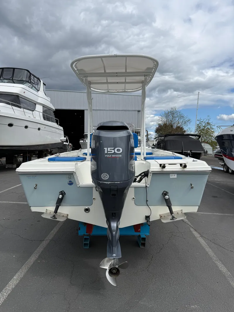 Slide: The Image of 2008 Sailfish 1900 BB Bay Boat with 150 HP engine, parked outdoors. - 4