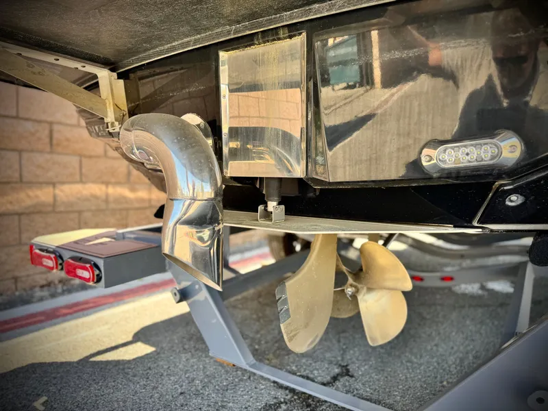 Slide: The Image of 2016 Nautique Super Air G23 boat propeller and exhaust detail. - 10