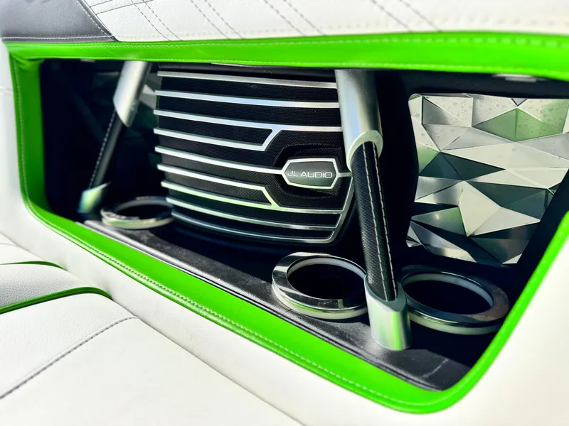 Slide: The Image of 2016 Nautique Super Air G23 interior with JL Audio system and vibrant green accents. - 18