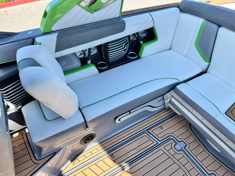 Slide: The Image of 2016 Nautique Super Air G23 interior with gray and green seating, featuring modern design and detailing. - 24