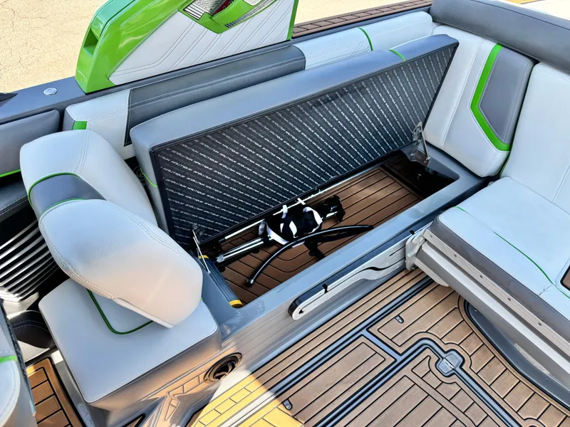 Slide: The Image of 2016 Nautique Super Air G23 boat interior with open storage compartment and stylish seating. - 25