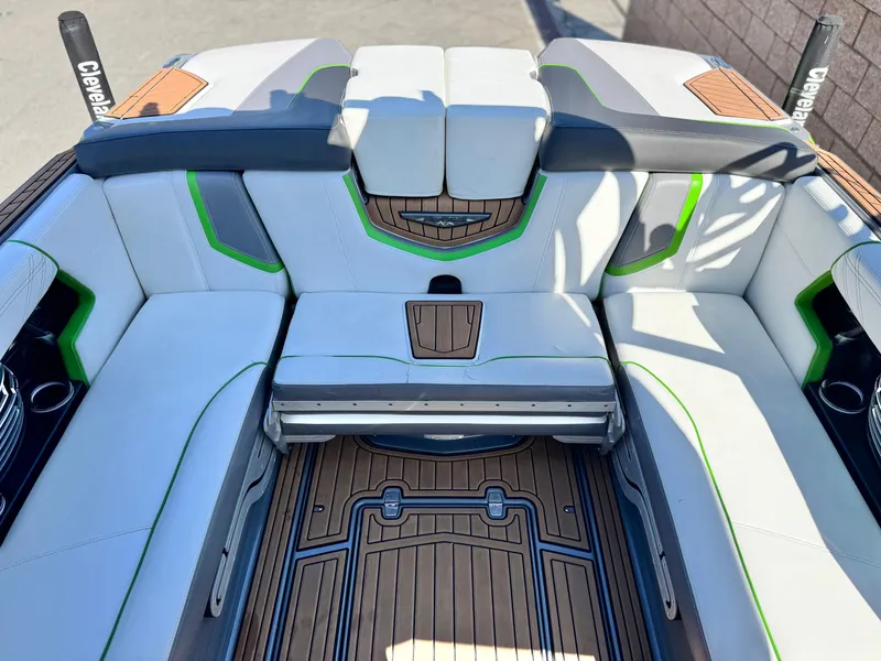 Slide: The Image of 2016 Nautique Super Air G23 boat interior with white and green seating, teak flooring. - 27