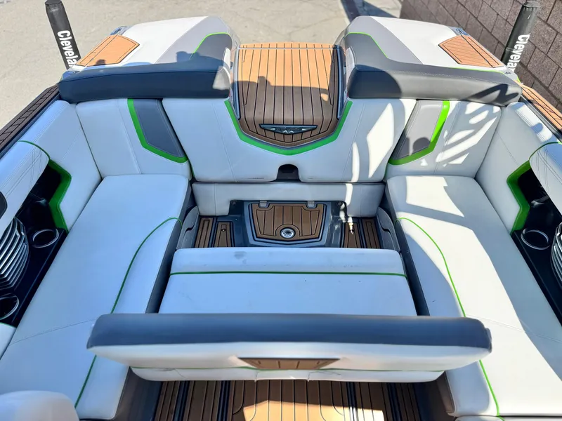 Slide: The Image of 2016 Nautique Super Air G23 boat interior with white and green seating. - 28