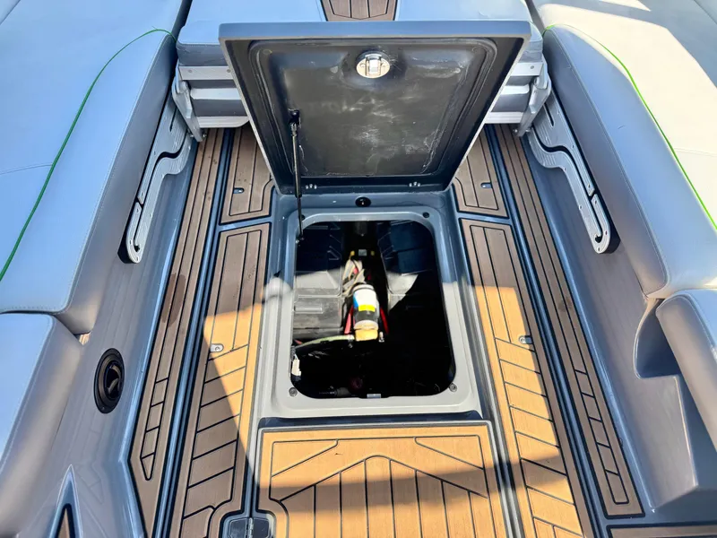 Slide: The Image of 2016 Nautique Super Air G23 boat storage compartment with open hatch, showcasing interior details. - 31