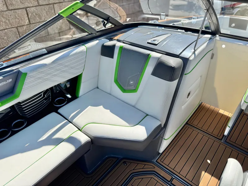Slide: The Image of 2016 Nautique Super Air G23 interior with white and green seating, wood-style flooring. - 32