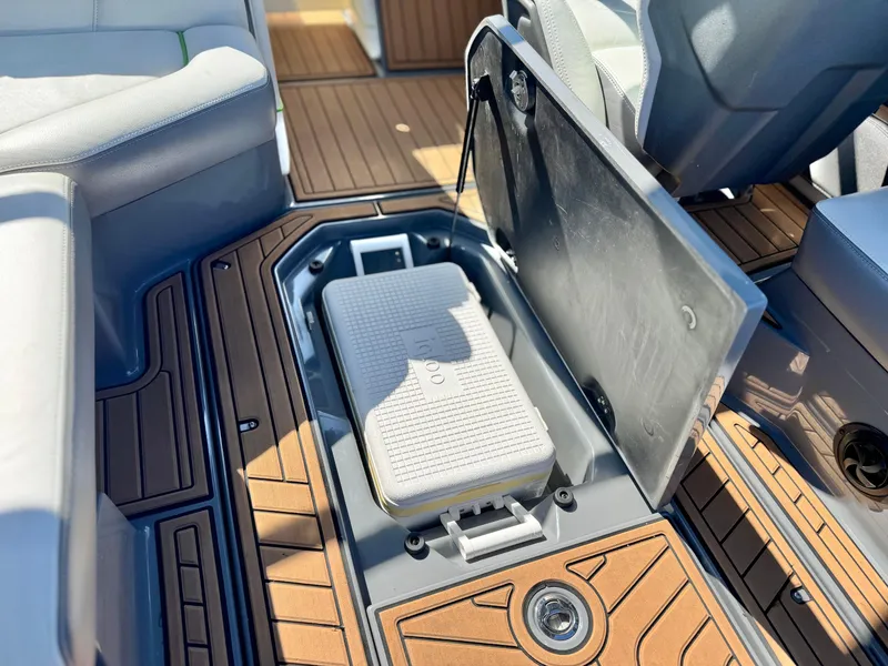 Slide: The Image of 2016 Nautique Super Air G23 interior with open storage compartment and teak flooring. - 35