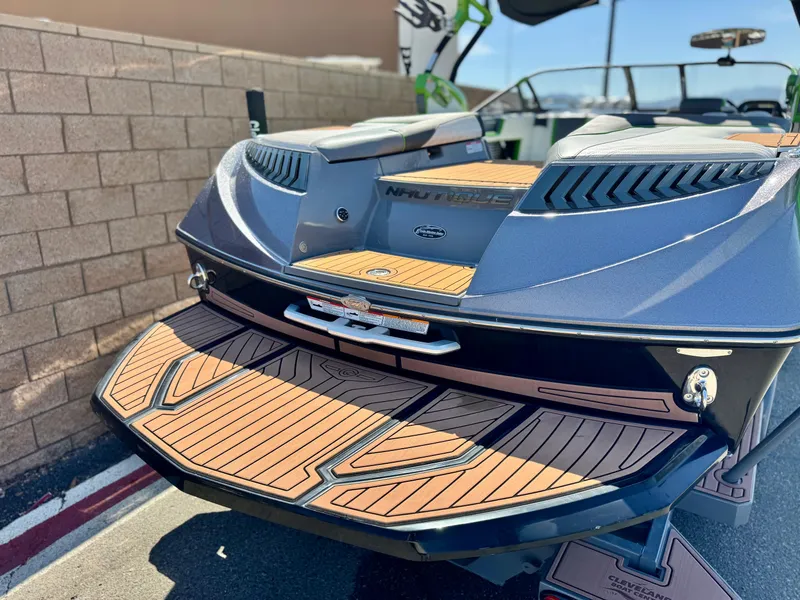 Slide: The Image of 2016 Nautique Super Air G23 boat with teak deck, parked outdoors. - 6
