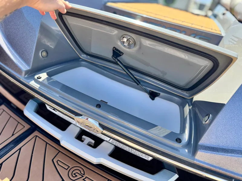Slide: The Image of 2016 Nautique Super Air G23 storage compartment open, showcasing interior details. - 7