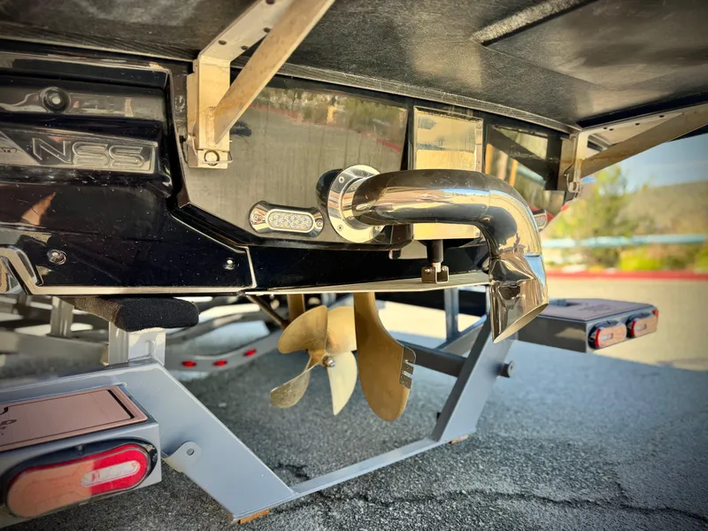 Slide: The Image of 2016 Nautique Super Air G23 boat propeller and exhaust detail on trailer. - 9