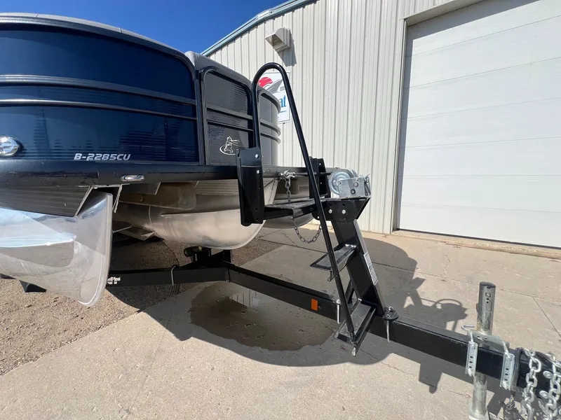 Slide: The Image of 2019 Misty Harbor 2285 Biscayne Bay CU pontoon boat on trailer, parked outside. - 27
