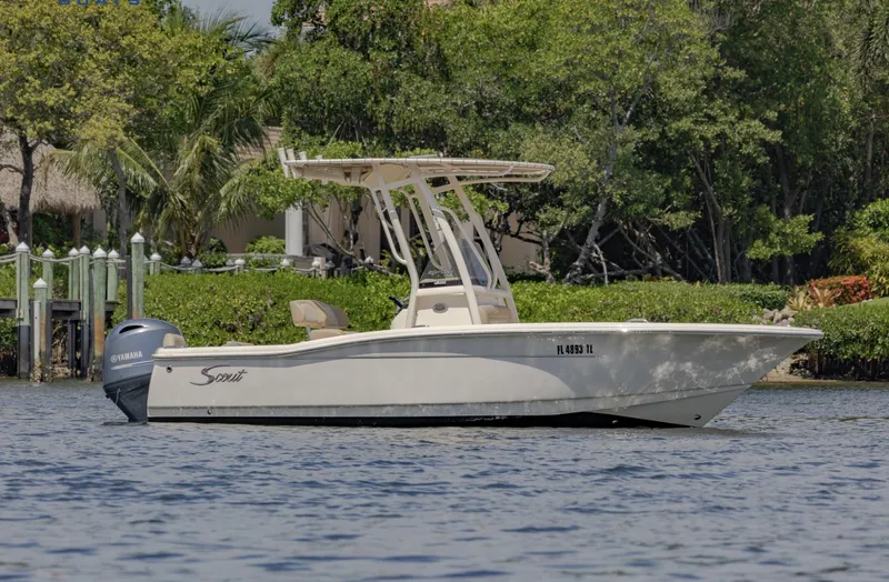 Slide: The Image of 2023 Scout 195 Sportfish boat on water, featuring sleek design and Yamaha outboard motor. - 0