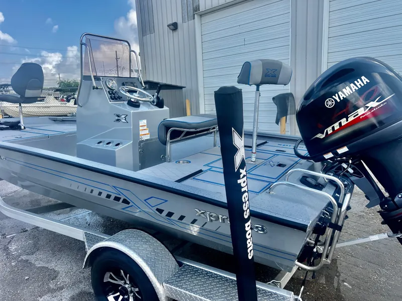 Slide: The Image of 2023 Xpress H190B boat with Yamaha VMAX engine, parked on a trailer. - 3