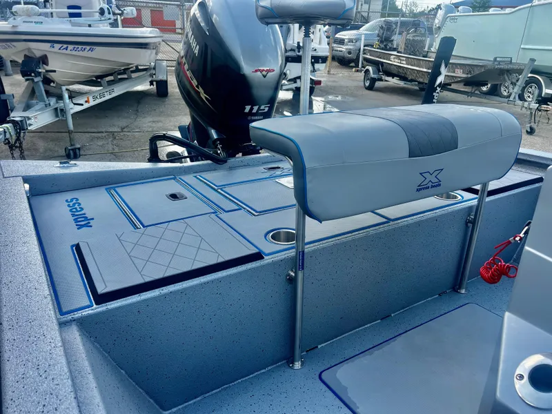 Slide: The Image of 2023 Xpress H190B boat interior with Yamaha 115 engine, featuring seating and storage compartments. - 5