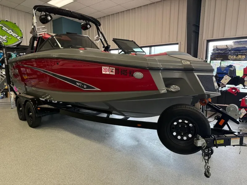 Slide: The Image of 2020 Heyday WT-2DC boat in showroom, red and gray design, on trailer. - 0