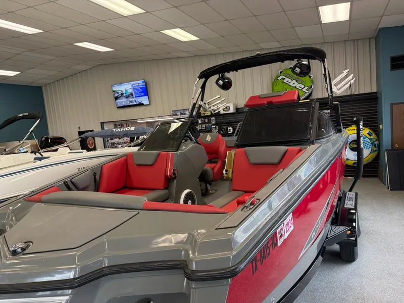 Slide: The Image of 2020 Heyday WT-2DC boat with red and gray interior, displayed in a showroom. - 1