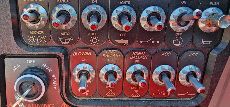 Slide: The Image of Control panel of a 2020 Heyday WT-2DC boat with various switches and knobs. - 14