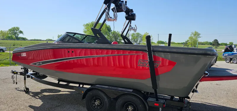Slide: The Image of 2020 Heyday WT-2DC boat in red and gray on a trailer, outdoors. - 5