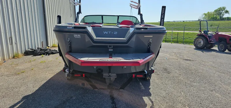 Slide: The Image of 2020 Heyday WT-2DC boat rear view, parked outdoors near a tractor. - 6