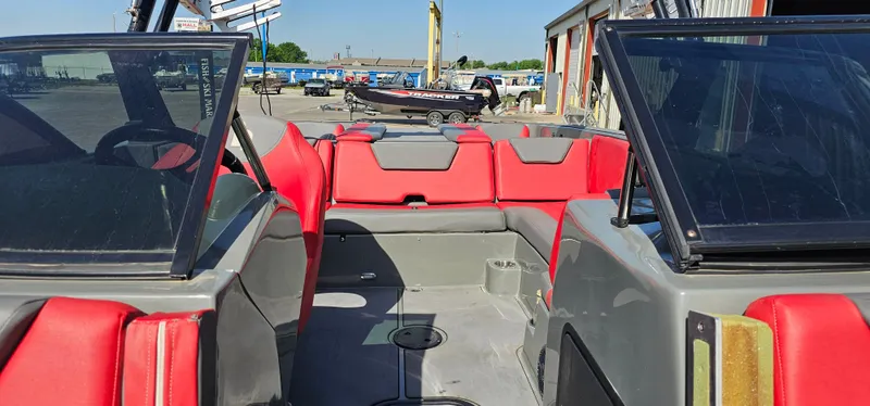Slide: The Image of 2020 Heyday WT-2DC boat interior with red and gray seating, docked outdoors. - 8