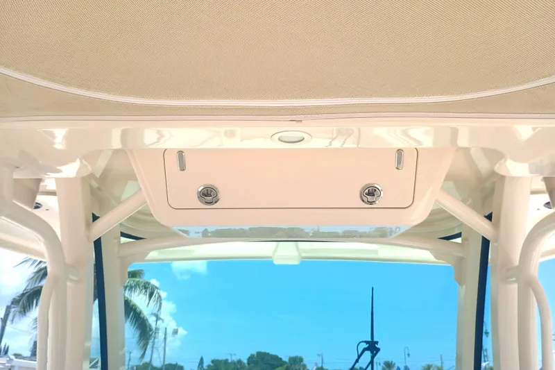 Slide: The Image of 2025 Grady-White Canyon 326 boat interior with storage compartment and clear sky view. - 23