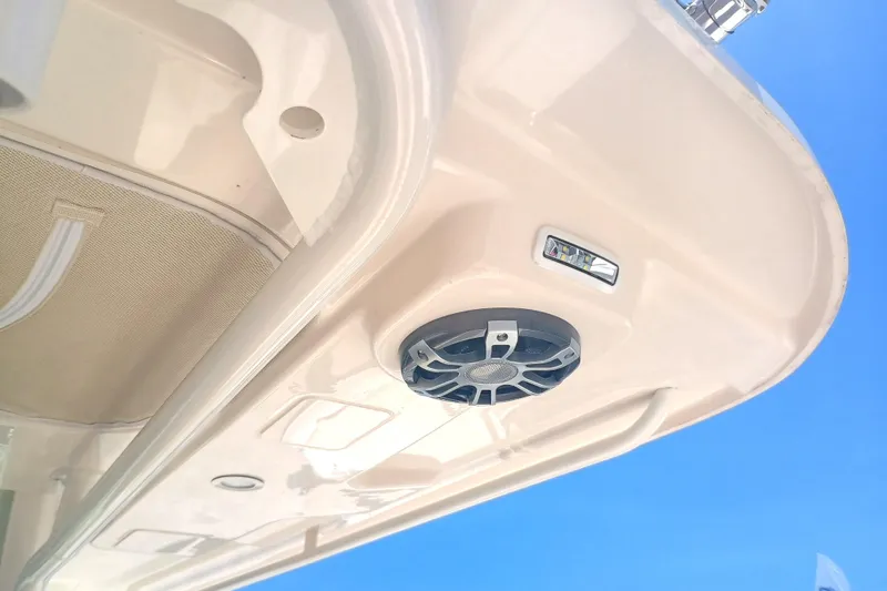 Slide: The Image of 2025 Grady-White Canyon 326 boat speaker and light detail against blue sky. - 24