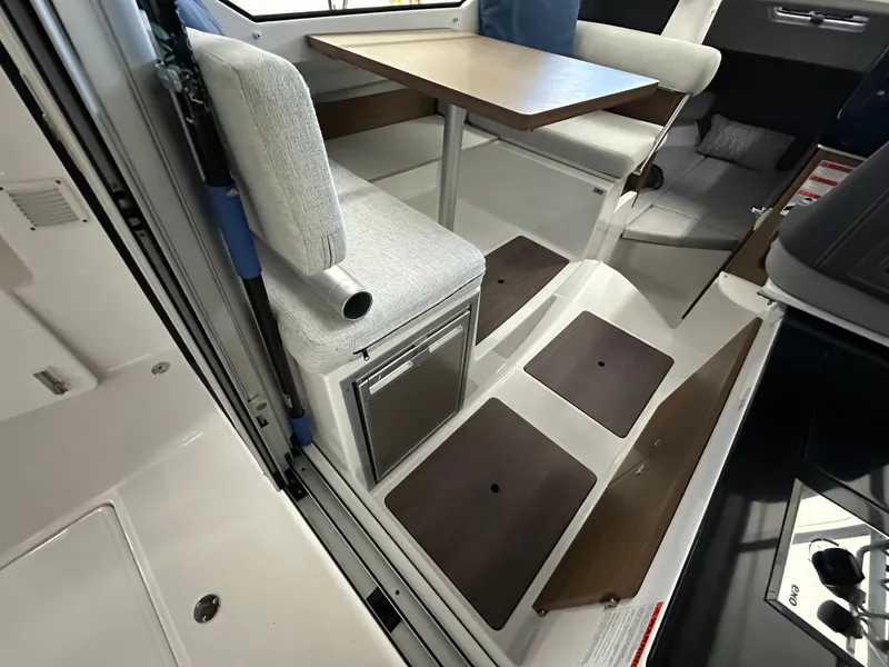 Slide: The Image of Interior of 2022 Jeanneau NC 795 boat with seating and storage compartments. - 12