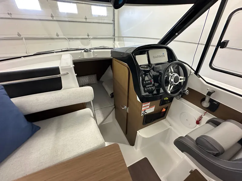 Slide: The Image of Interior of 2022 Jeanneau NC 795 boat with modern helm and seating area. - 14