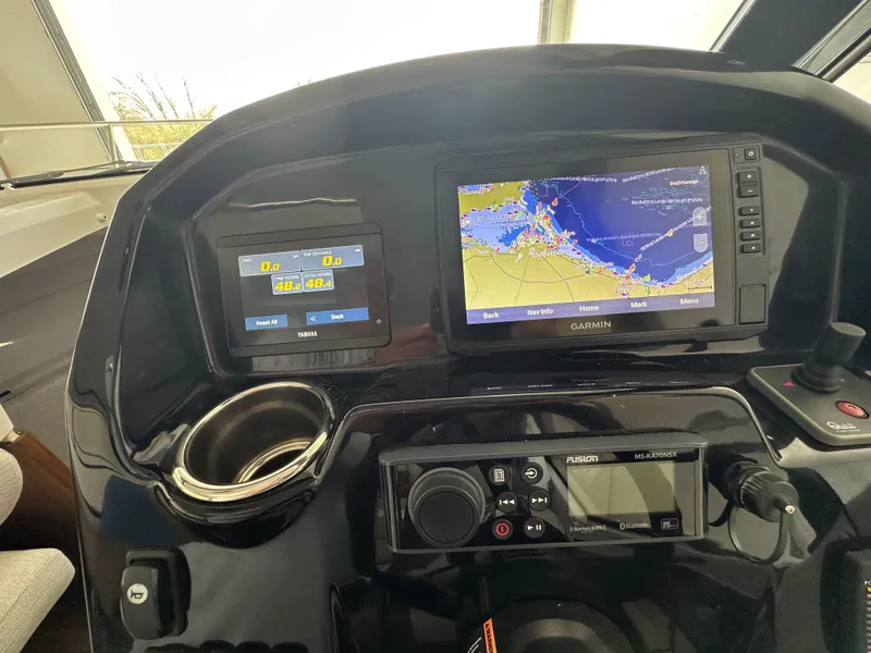 Slide: The Image of Dashboard of 2022 Jeanneau NC 795 with Garmin navigation system and controls. - 16