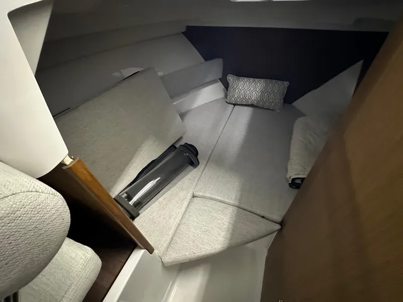 Slide: The Image of 2022 Jeanneau NC 795 cabin interior with cozy seating and cushions. - 18