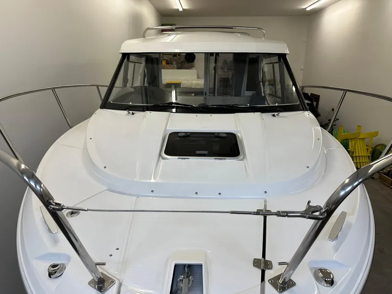 Slide: The Image of 2022 Jeanneau NC 795 boat in storage, showcasing sleek design and modern features. - 3