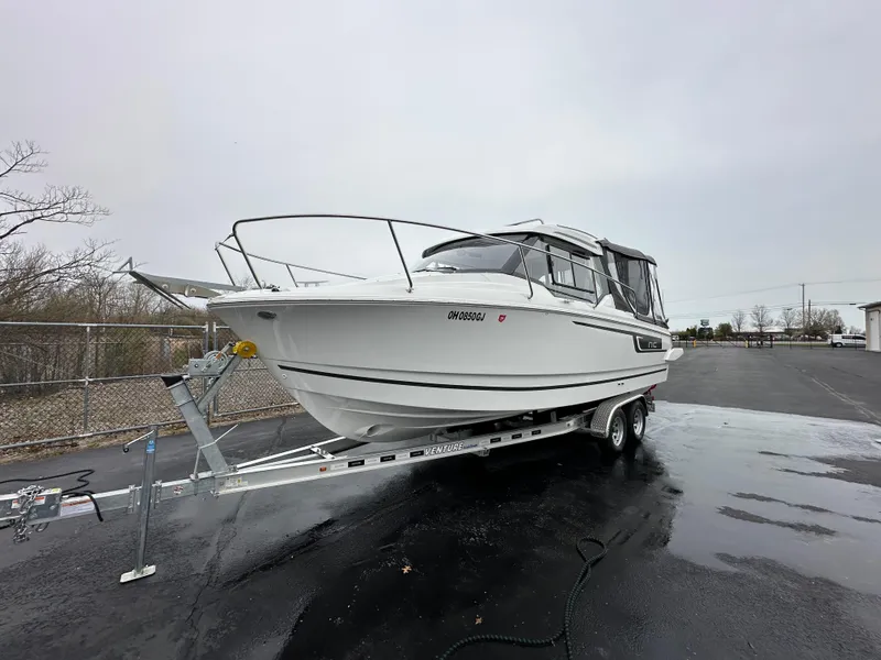 Slide: The Image of 2022 Jeanneau NC 795 boat on trailer, parked on wet pavement. - 5