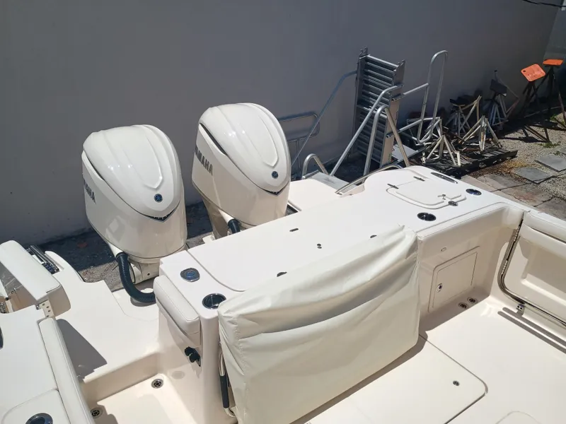 Slide: The Image of 2025 Grady-White Canyon 326 boat with dual Yamaha outboard engines, docked outdoors. - 10
