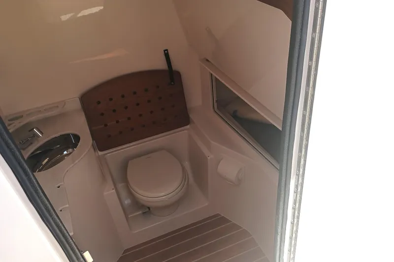 Slide: The Image of 2025 Grady-White Canyon 326 boat interior bathroom with sink and toilet. - 12
