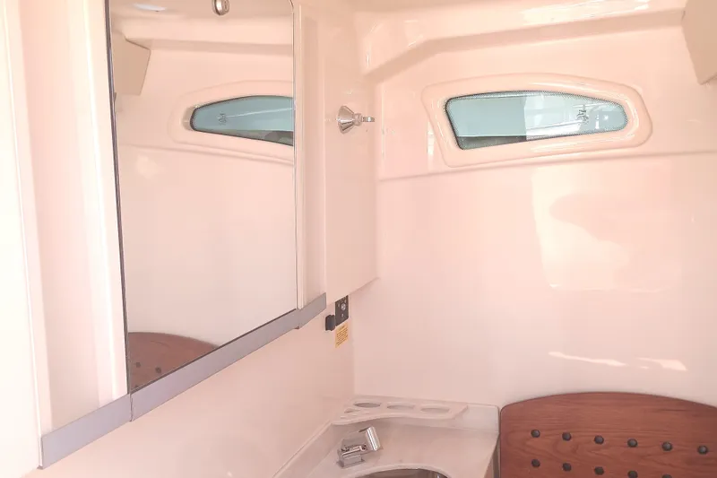 Slide: The Image of 2025 Grady-White Canyon 326 boat interior with mirror and porthole window. - 14