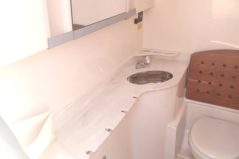 Slide: The Image of 2025 Grady-White Canyon 326 boat bathroom with sink and toilet. - 15