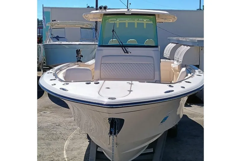 Slide: The Image of 2025 Grady-White Canyon 326 boat, front view, docked outdoors. - 2