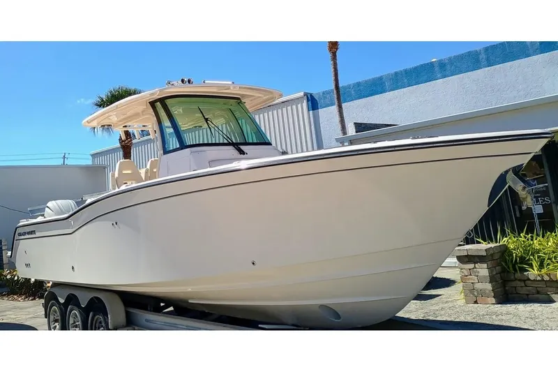 Slide: The Image of 2025 Grady-White Canyon 326 boat on trailer, sleek design, outdoor display. - 4