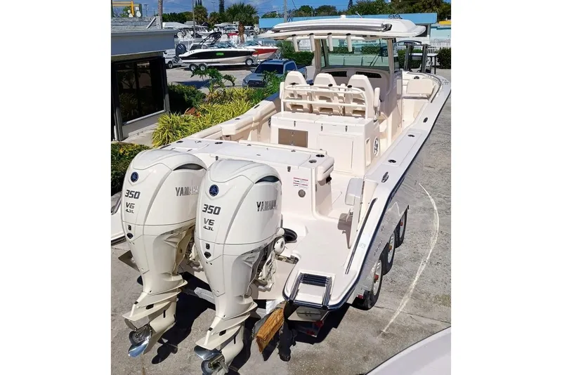 Slide: The Image of 2025 Grady-White Canyon 326 boat with twin Yamaha 350 engines, docked outdoors. - 6