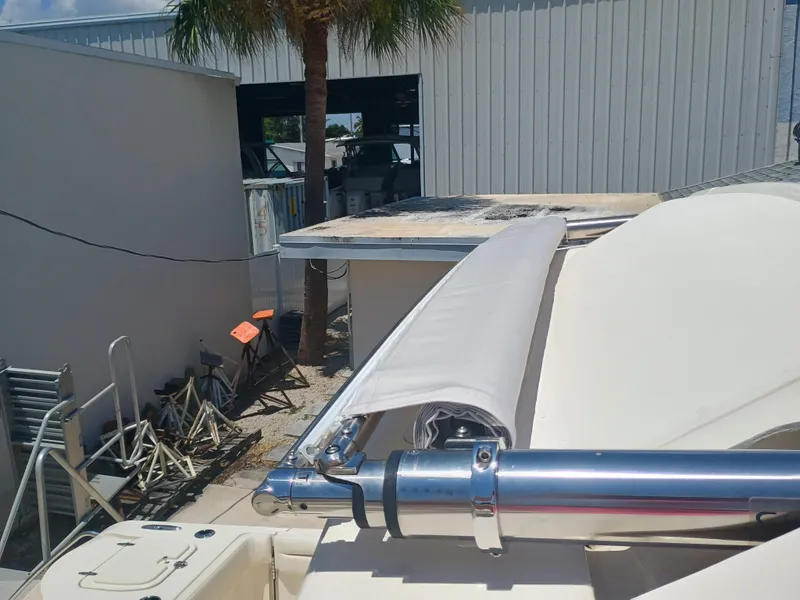 Slide: The Image of 2025 Grady-White Canyon 326 boat detail with rolled-up canvas and metal railing. - 9