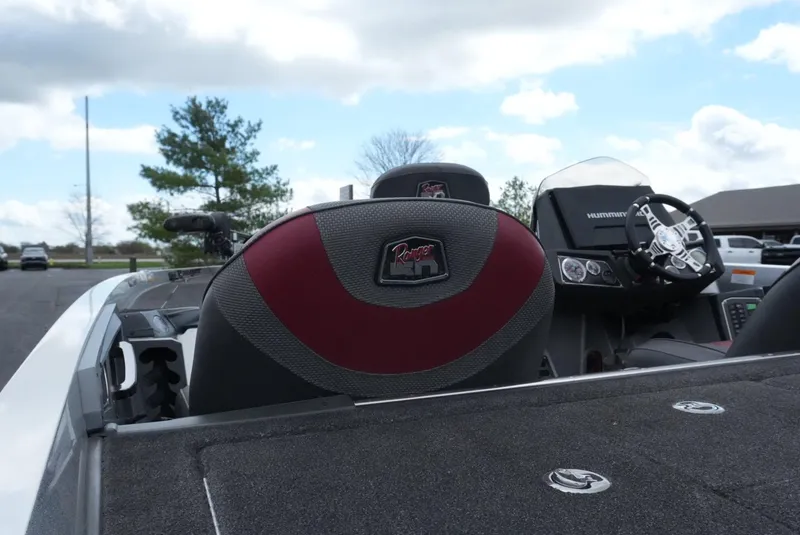 Slide: The Image of 2018 Ranger Z520L boat interior with steering wheel and seat, under a partly cloudy sky. - 11