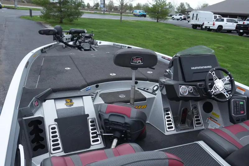 Slide: The Image of 2018 Ranger Z520L boat interior with steering wheel, seats, and fishing equipment. - 12