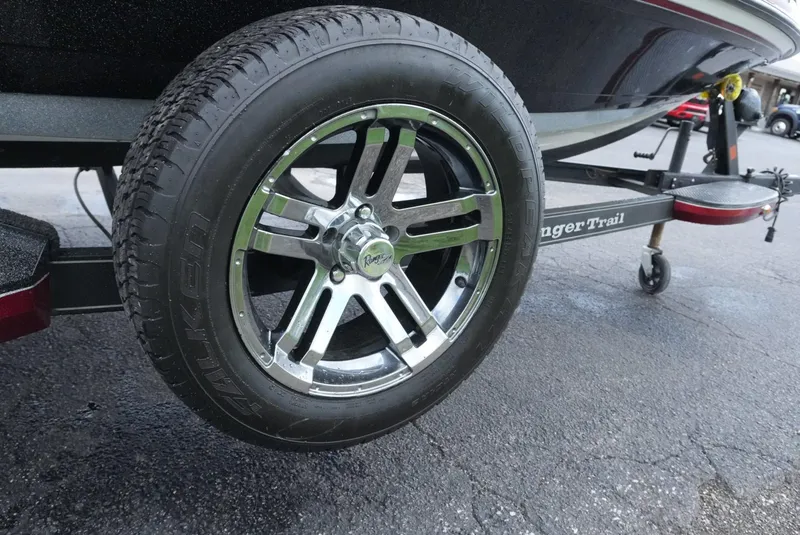 Slide: The Image of 2018 Ranger Z520L boat trailer with chrome wheel on asphalt. - 5