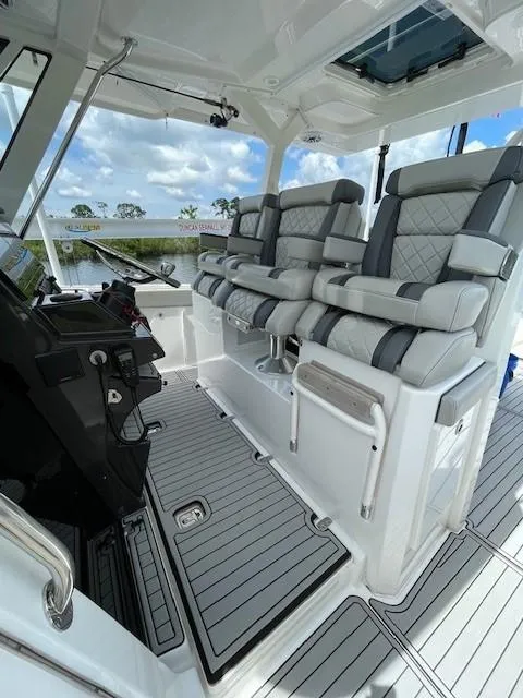 Slide: The Image of 2023 Pursuit S 378 Sport boat interior with luxurious seating and modern dashboard. - 11