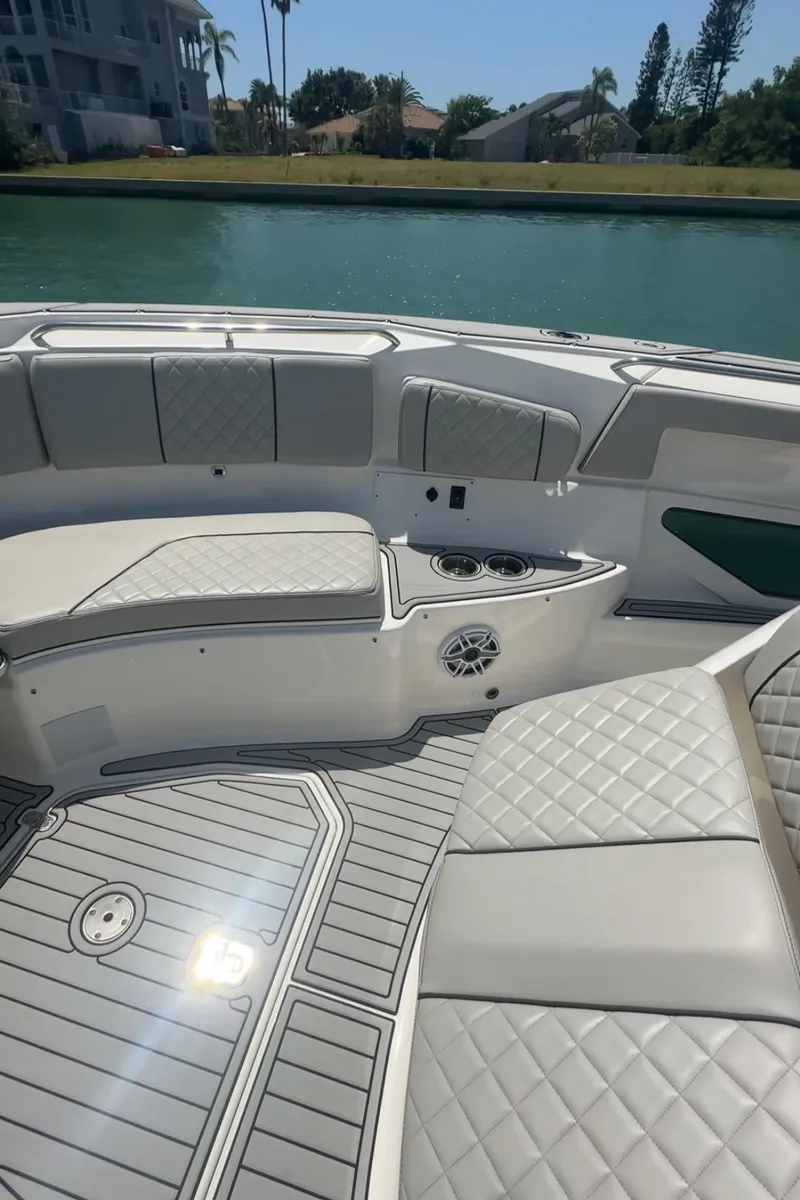 Slide: The Image of 2023 Pursuit S 378 Sport boat interior with quilted seating and cup holders. - 13