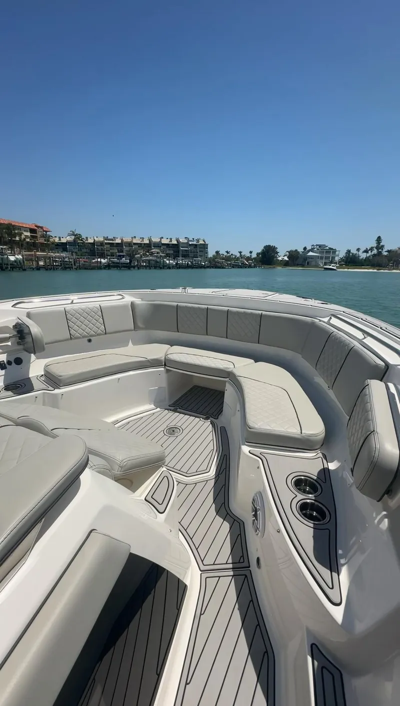 Slide: The Image of 2023 Pursuit S 378 Sport boat interior with luxurious seating and ocean view. - 15