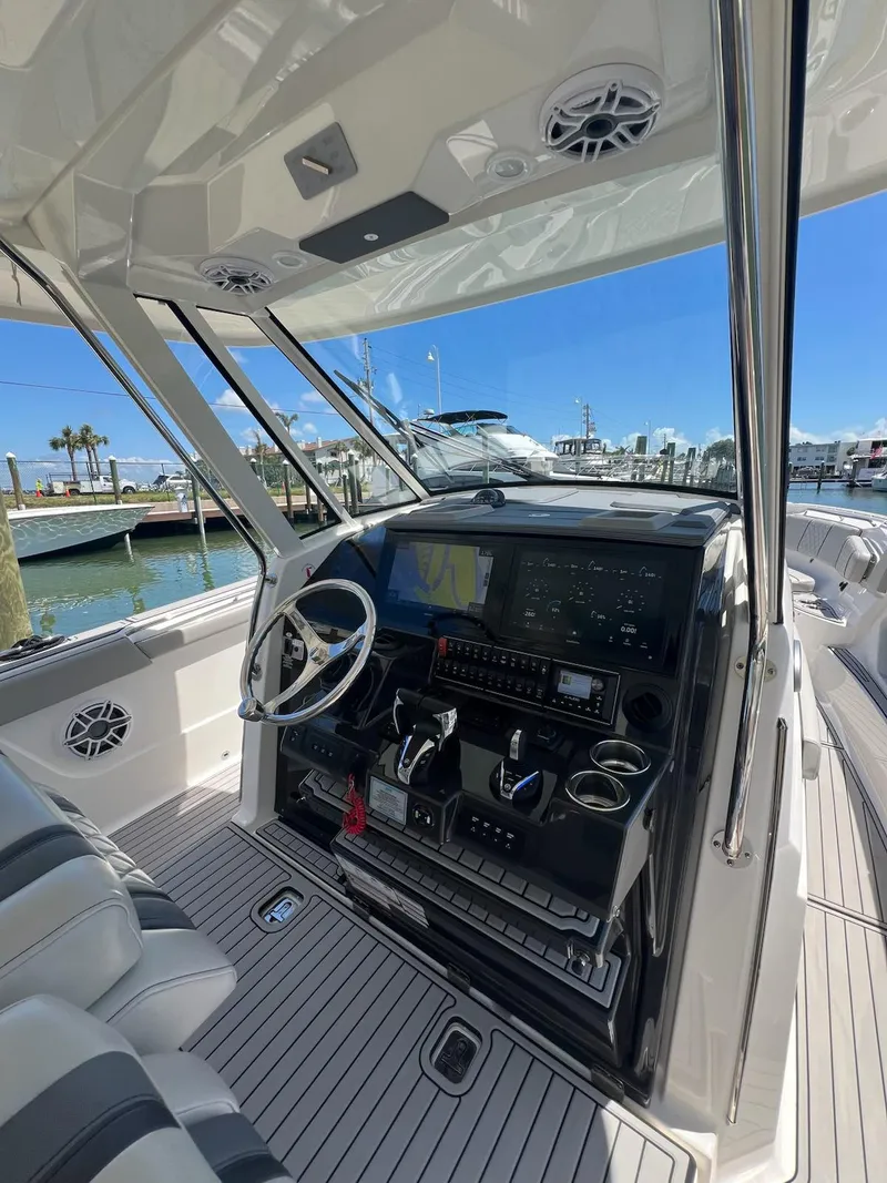 Slide: The Image of 2023 Pursuit S 378 Sport boat cockpit with advanced navigation system and sleek design. - 8