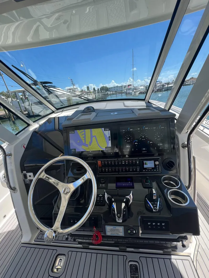 Slide: The Image of 2023 Pursuit S 378 Sport boat dashboard with navigation system and steering wheel. - 9