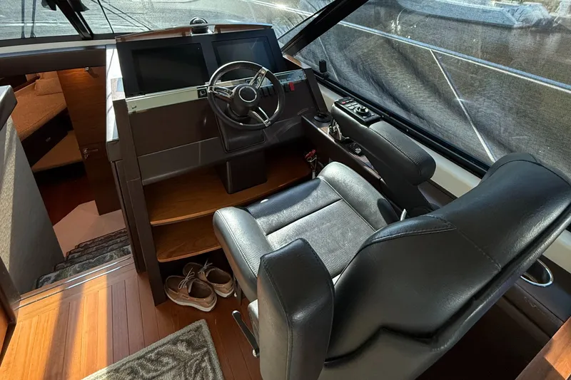 Slide: The Image of 2016 Tiara Yachts 50 Coupe helm with leather seat and steering wheel. - 13