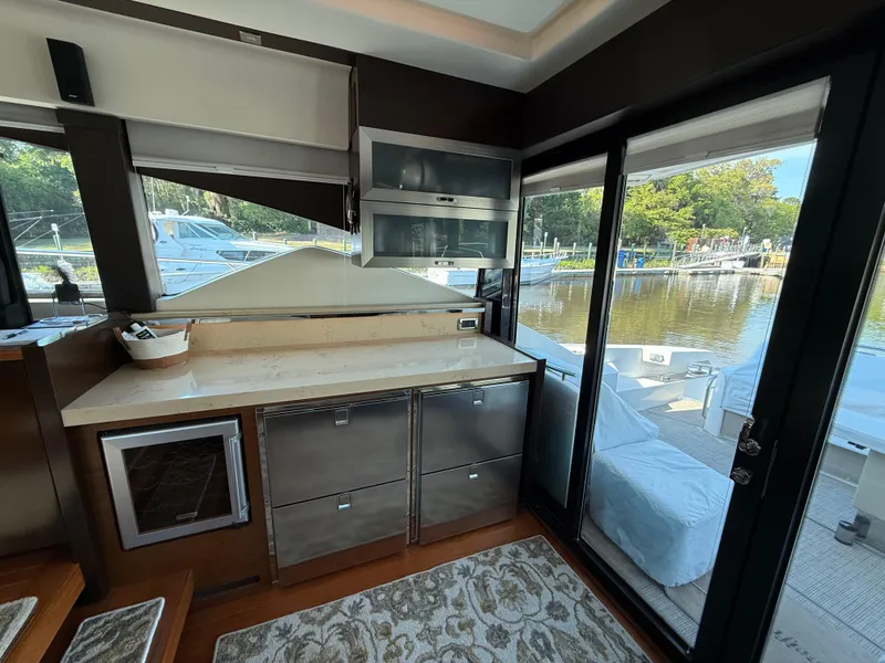 Slide: The Image of Interior of 2016 Tiara Yachts 50 Coupe with modern kitchen and marina view. - 15