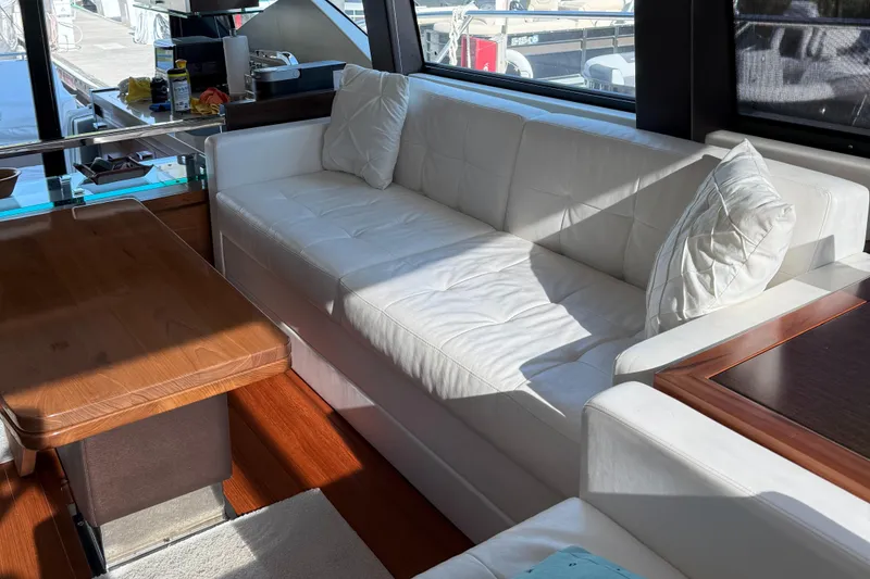 Slide: The Image of Luxurious interior of 2016 Tiara Yachts 50 Coupe with white sofa and wooden table. - 16
